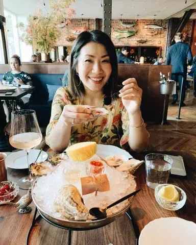 A woman enjoys fresh seafood at San Francisco's Angler restaurant